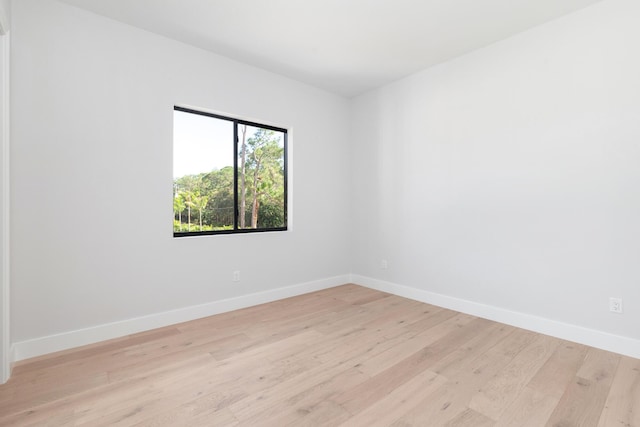 spare room with light hardwood / wood-style flooring