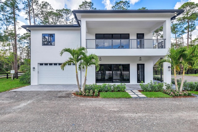 view of front facade featuring a garage and a balcony