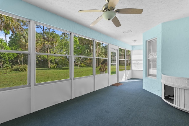 unfurnished sunroom featuring ceiling fan