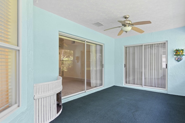 interior space with ceiling fan