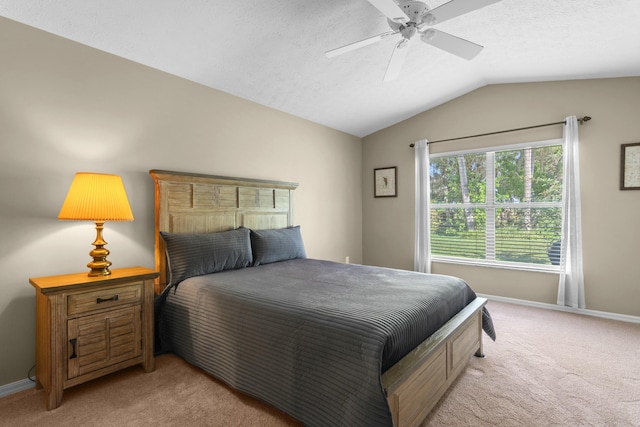 bedroom featuring a textured ceiling, light carpet, vaulted ceiling, and ceiling fan