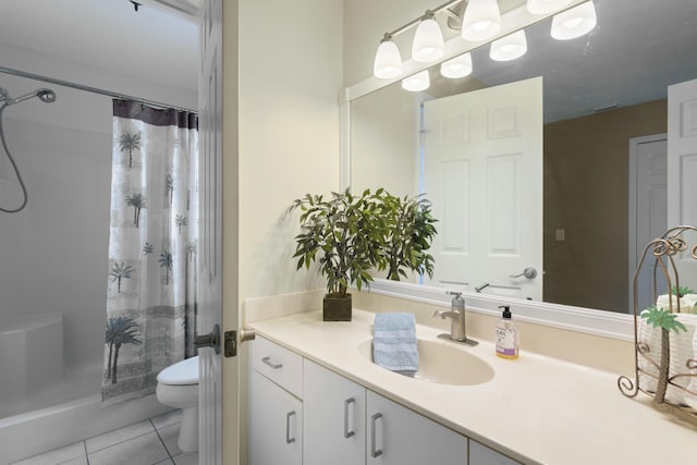 bathroom with vanity, toilet, tile patterned floors, and walk in shower