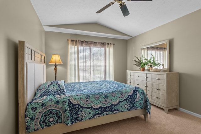 carpeted bedroom featuring vaulted ceiling, ceiling fan, and a textured ceiling