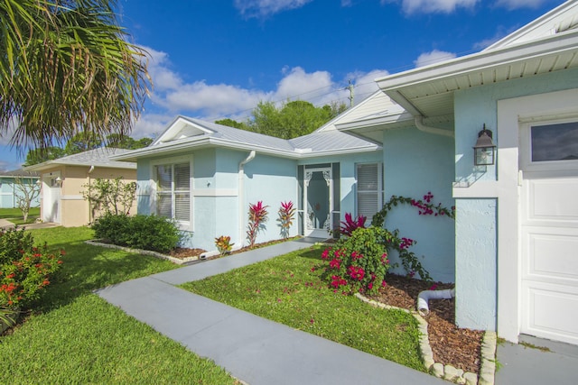 property entrance with a yard