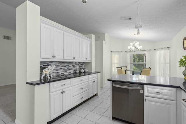 kitchen with stainless steel dishwasher, light tile patterned floors, white cabinetry, and backsplash