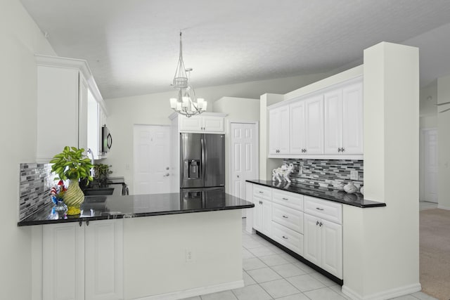 kitchen featuring kitchen peninsula, stainless steel fridge with ice dispenser, tasteful backsplash, light tile patterned floors, and white cabinets