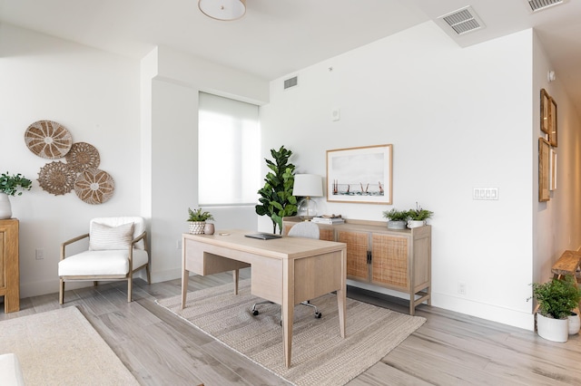 office space with light wood-type flooring