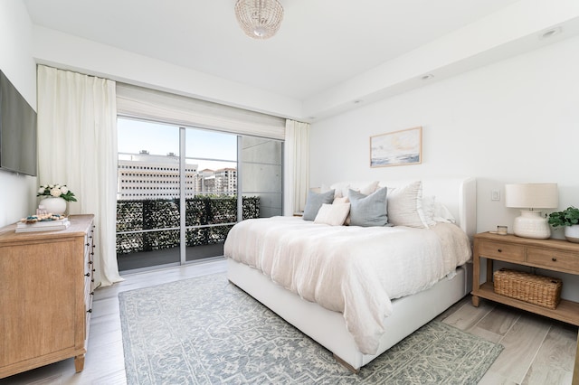 bedroom featuring access to exterior and light hardwood / wood-style flooring