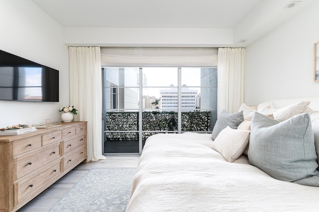 bedroom with light hardwood / wood-style flooring and access to exterior