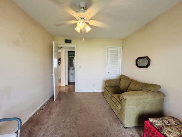 carpeted living area featuring ceiling fan, visible vents, and baseboards