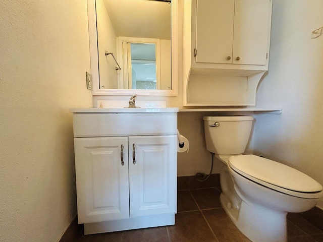 bathroom with toilet, tile patterned floors, and vanity