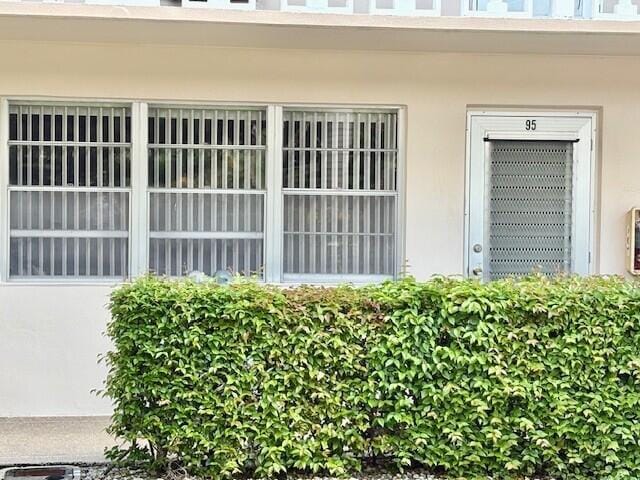 property entrance with stucco siding