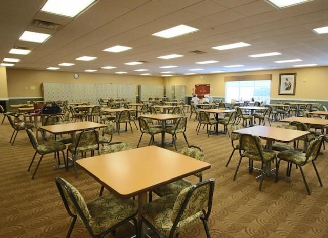 dining area with visible vents and a drop ceiling