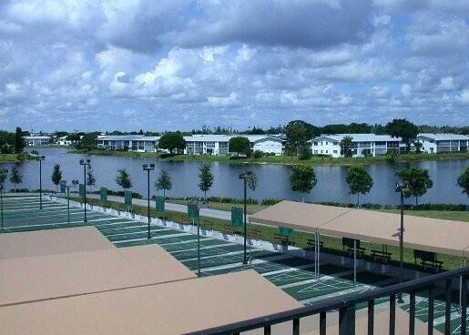 view of community featuring a water view and shuffleboard