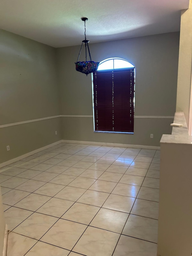 1732 SW Alegre St, Port Saint Lucie, FL 34953 - unfurnished dining area featuring light tile patterned floors and baseboards