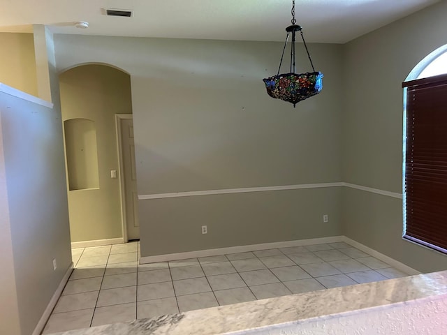 1732 SW Alegre St, Port Saint Lucie, FL 34953 - unfurnished room with light tile patterned floors, arched walkways, visible vents, and baseboards