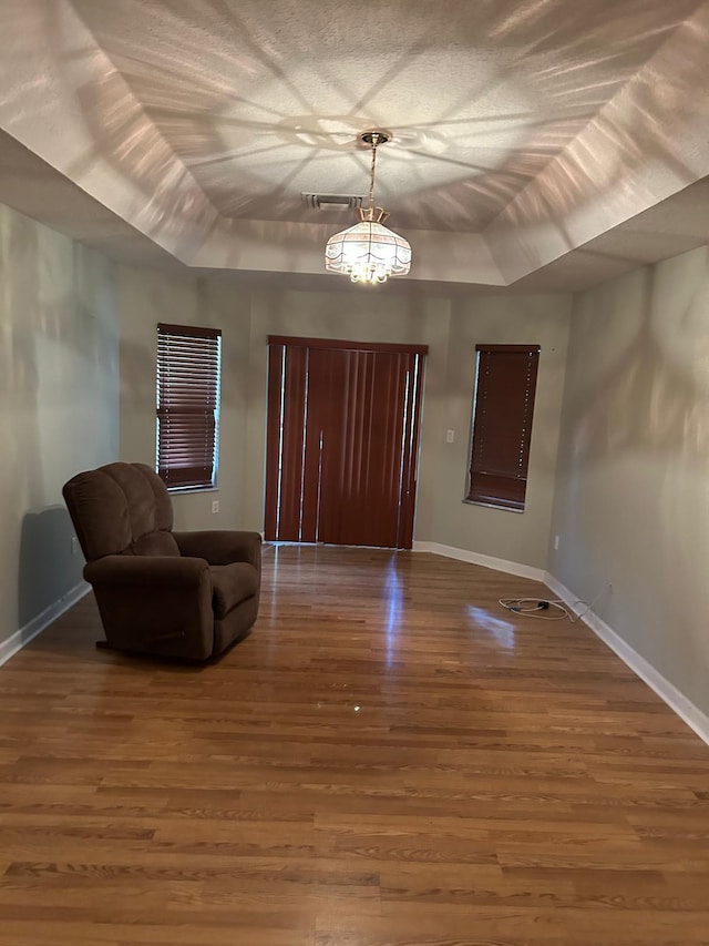 1732 SW Alegre St, Port Saint Lucie, FL 34953 - entrance foyer featuring wood finished floors, a tray ceiling, and baseboards