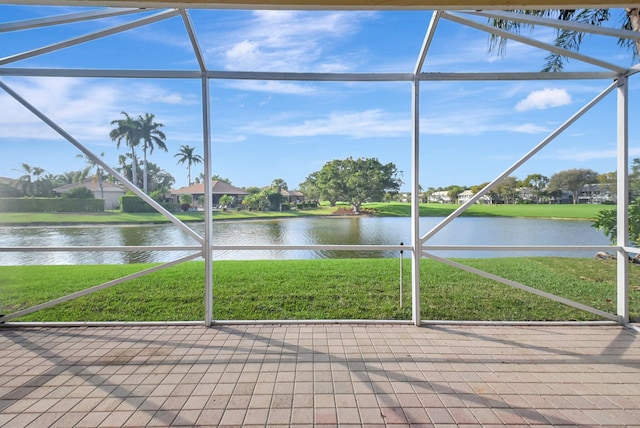 unfurnished sunroom featuring a water view