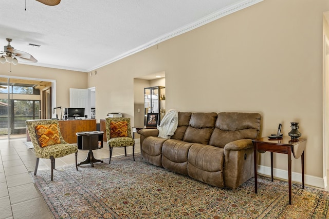 living room featuring ornamental molding, tile patterned flooring, a ceiling fan, and baseboards