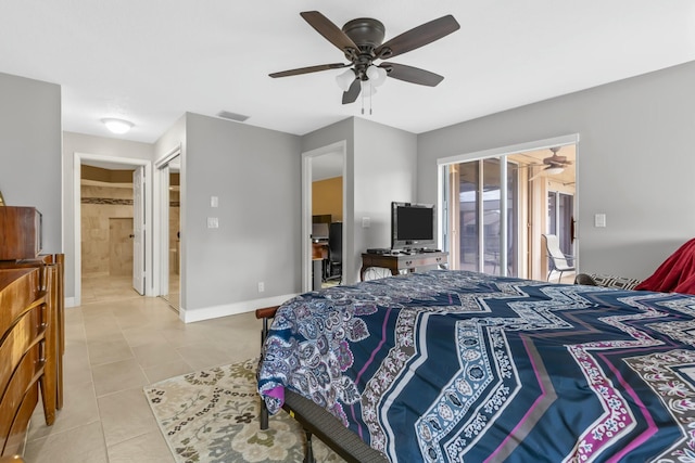 tiled bedroom featuring a ceiling fan, visible vents, ensuite bath, and baseboards