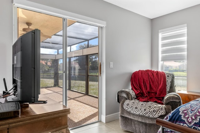 doorway with baseboards and tile patterned floors