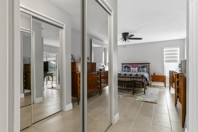 bedroom with ceiling fan and tile patterned floors