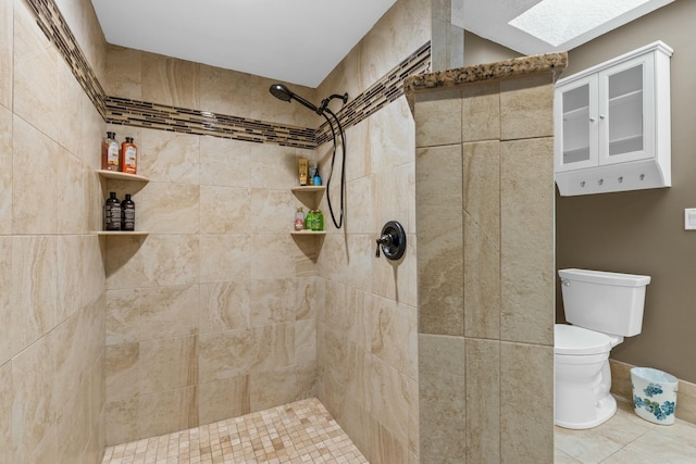 full bathroom with a skylight, a tile shower, and toilet