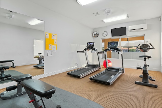 gym featuring visible vents, baseboards, and a wall mounted AC