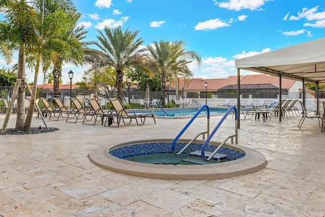 view of home's community featuring a patio area, fence, and a pool