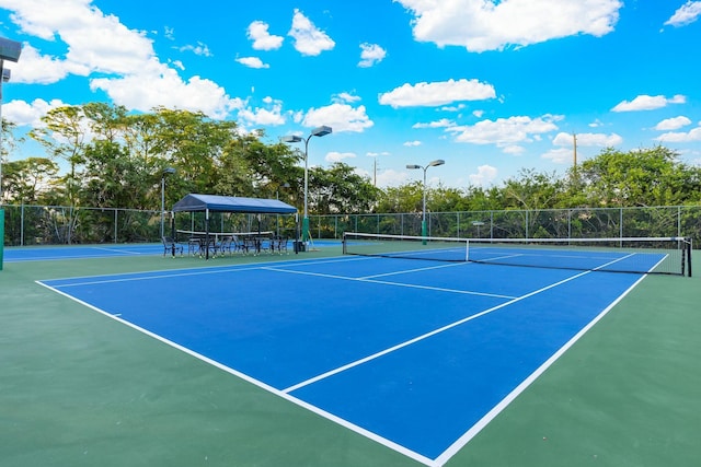 view of sport court featuring fence