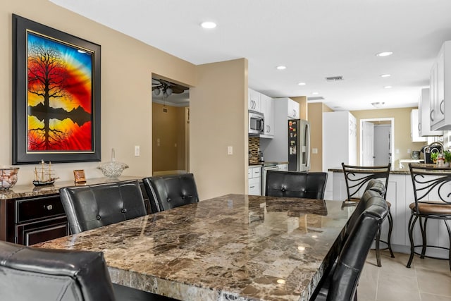 dining space featuring light tile patterned floors, visible vents, and recessed lighting