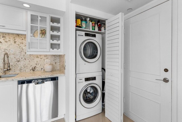 875 E Camino Real Unit 7E, Boca Raton, FL 33432 - laundry area with stacked washer and dryer and sink