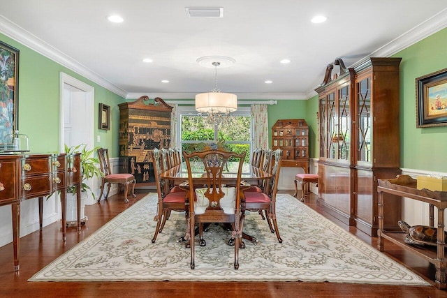 dining space with recessed lighting, dark wood-style floors, an inviting chandelier, ornamental molding, and visible vents