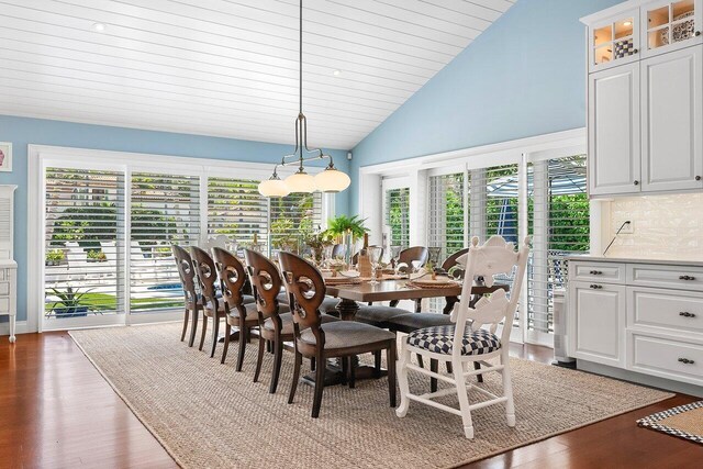 dining area with high vaulted ceiling, a healthy amount of sunlight, and dark wood finished floors