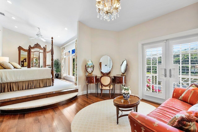 bedroom with visible vents, an inviting chandelier, baseboards, wood finished floors, and recessed lighting