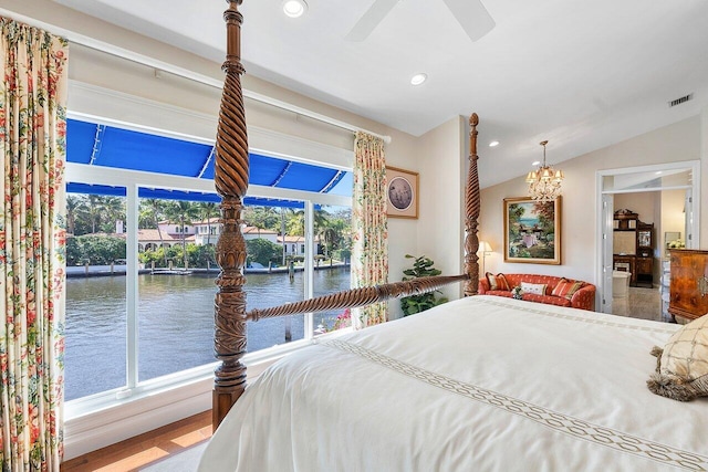 bedroom featuring visible vents, recessed lighting, a water view, ceiling fan with notable chandelier, and vaulted ceiling