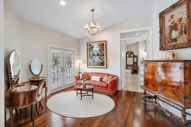 sitting room with a chandelier, dark wood-type flooring, lofted ceiling, recessed lighting, and french doors