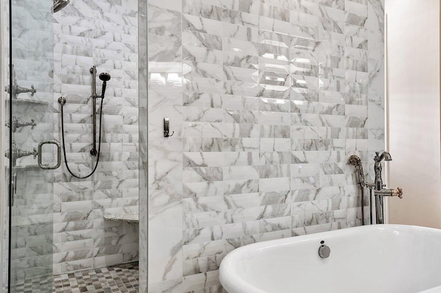 full bath featuring a freestanding tub and a shower stall