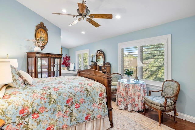 bedroom featuring a ceiling fan, wood finished floors, baseboards, recessed lighting, and vaulted ceiling