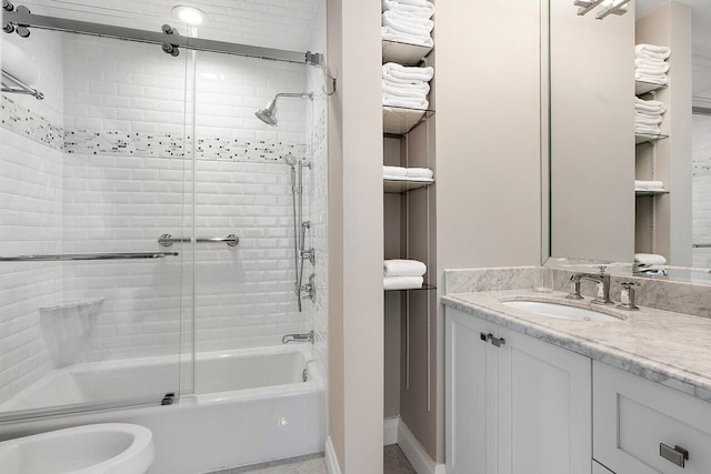 bathroom featuring vanity and bath / shower combo with glass door