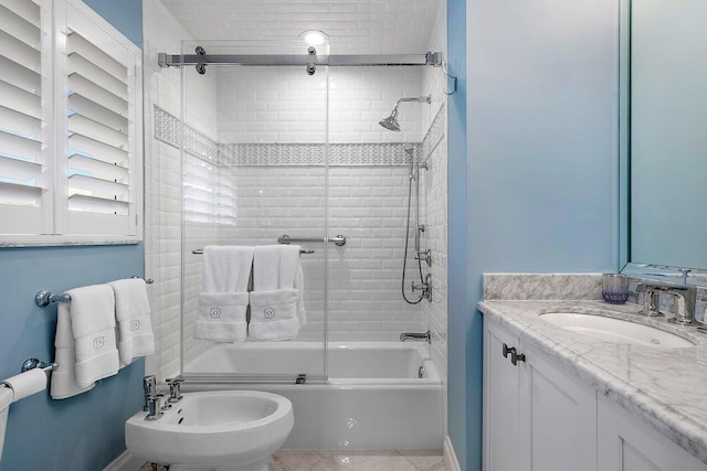 bathroom featuring a bidet, vanity, and enclosed tub / shower combo