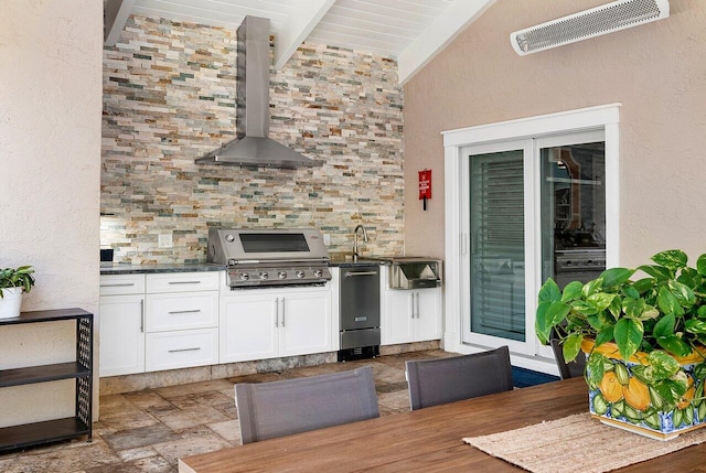 view of patio featuring visible vents, area for grilling, and exterior kitchen