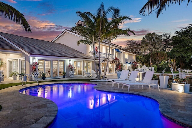 pool featuring french doors and a patio area