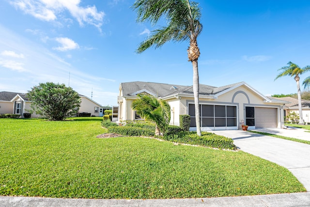 view of front of home with stucco siding, a garage, concrete driveway, and a front lawn