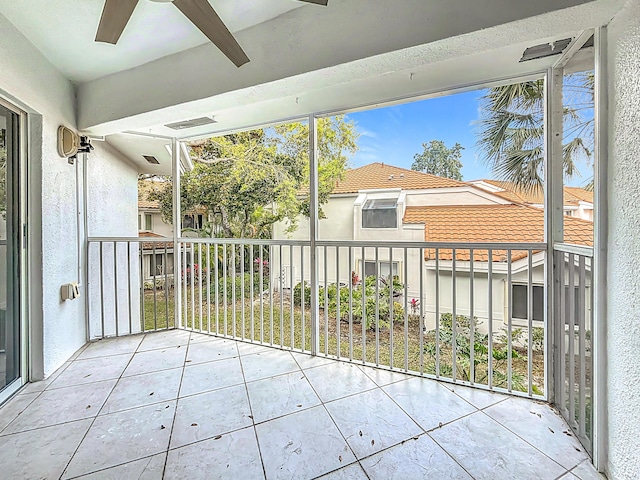 unfurnished sunroom with a ceiling fan