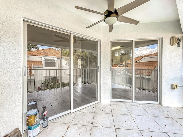 unfurnished sunroom featuring ceiling fan