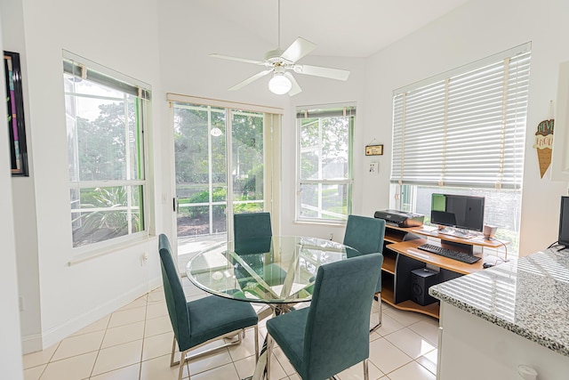 dining space with light tile patterned floors, ceiling fan, and baseboards