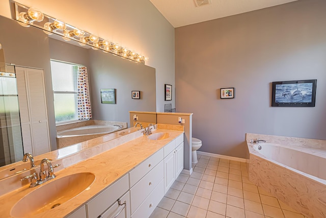 full bath featuring a closet, a sink, toilet, and tile patterned floors