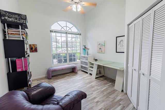 interior space with light wood finished floors, ceiling fan, and baseboards