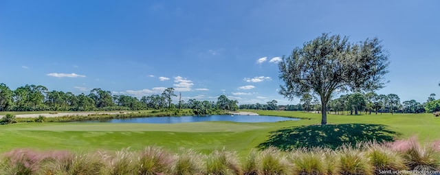 view of property's community featuring golf course view, a water view, and a lawn